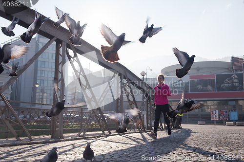 Image of sporty woman jogging on morning