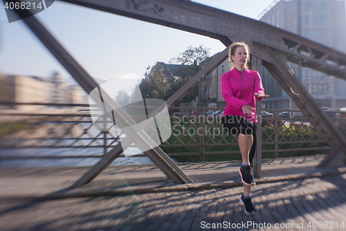 Image of woman  stretching before morning jogging