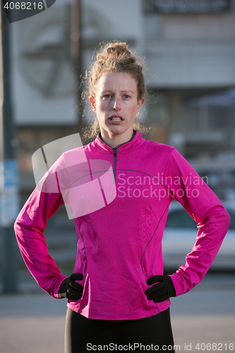 Image of woman  stretching before morning jogging