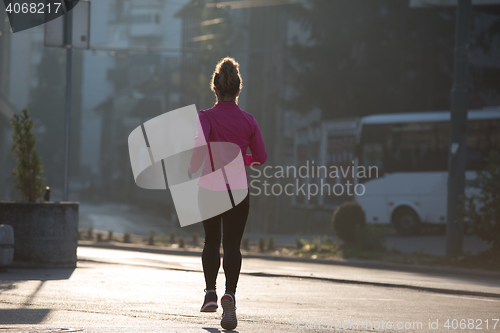 Image of sporty woman jogging on morning