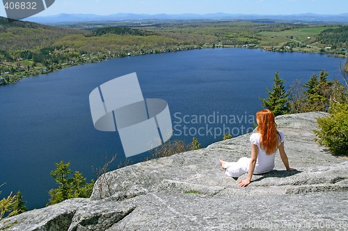 Image of Young woman enjoying the view over lake