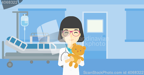 Image of Pediatrician doctor holding teddy bear.