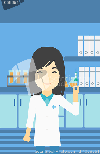 Image of Laboratory assistant with syringe in lab.
