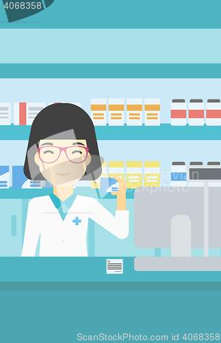 Image of Pharmacist showing some medicine.