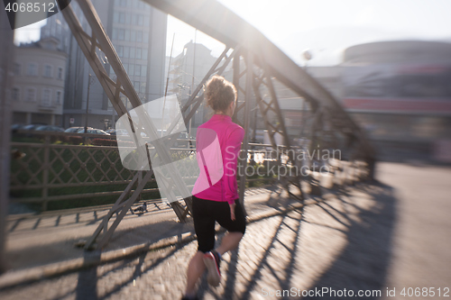 Image of sporty woman jogging on morning