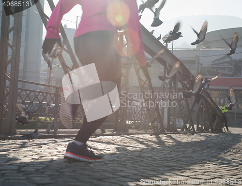 Image of sporty woman jogging on morning