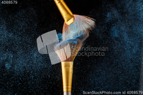 Image of Two brushes for shadows with feather shadow on black background