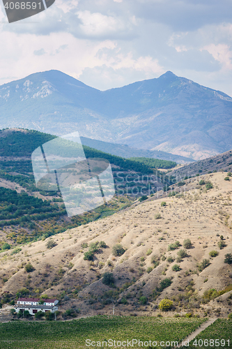 Image of Silent scenic terrain, hills, mountains and lonely house