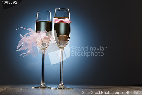 Image of Champagne glasses with pink grooms bow-tie and brides veil