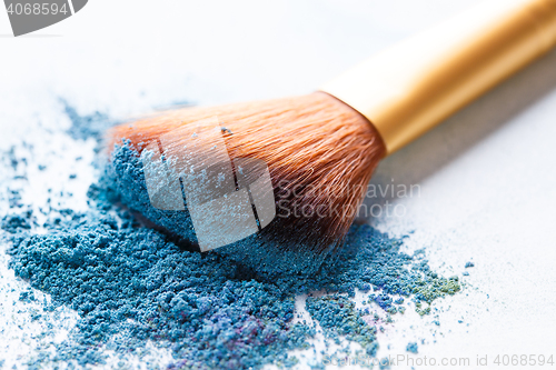 Image of Brush lies scattered on blue shadows at white background