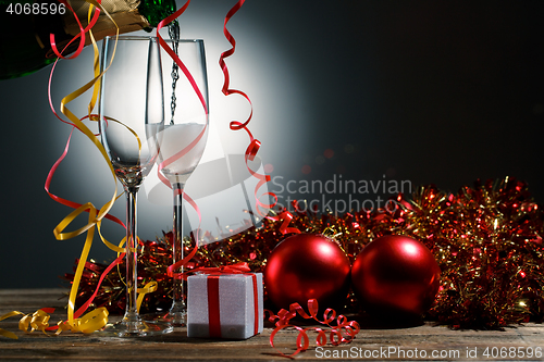 Image of Champagne poured into glasses and Christmas decoration