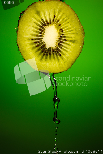 Image of Piece of kiwi with water drops