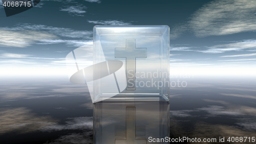 Image of christian cross in glass cube under cloudy sky - 3d rendering