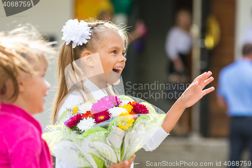 Image of First-grader at the school the first of September in greeting waving his girlfriend