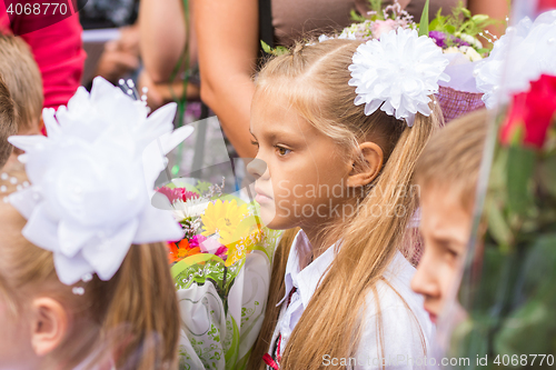 Image of First grader standing in a crowd of children on line the first of September