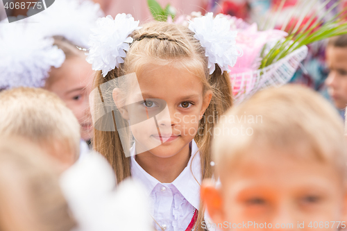 Image of First grader close-up in a crowd of children on line the first of September