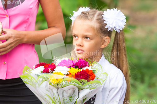 Image of Portrait of a seven-year schoolgirl, standing next to my mother