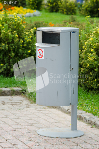 Image of Neat metal urn on a background of manicured lawns