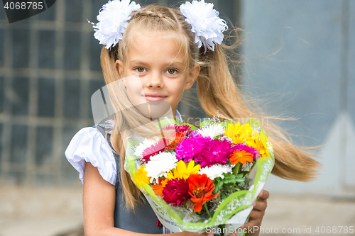 Image of Up portrait of first-grader with a bouquet of flowers