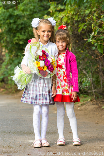 Image of Portrait first grader and her younger sister on the way to school