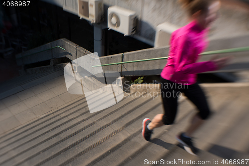 Image of woman jogging on  steps
