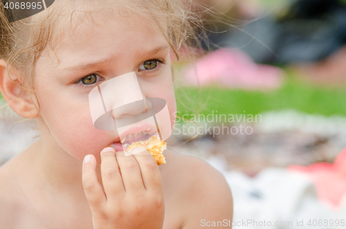 Image of Girl eating cookies and drinking juice from a plastic disposable cup