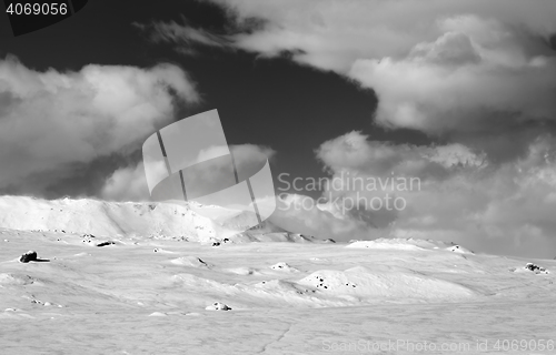 Image of Ice-covered slope and snowy mountains in fog