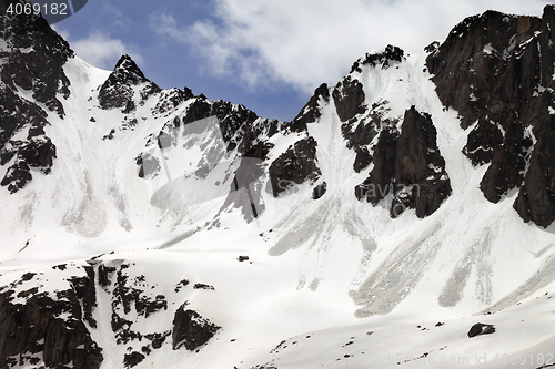 Image of Snow rocks with traces from avalanche in sun spring day