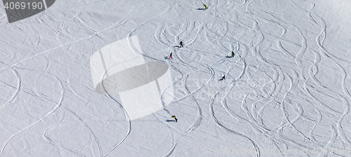 Image of Panoramic view on snowboarders and skiers downhill on off piste 