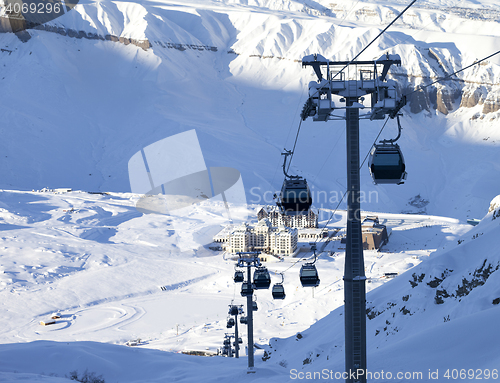 Image of Gondola lift on ski resort at winter sun evening