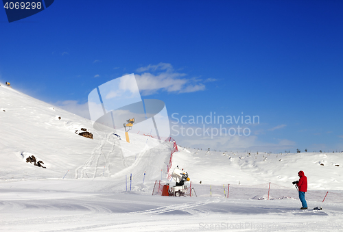 Image of Skier on snow ski slope at sun day