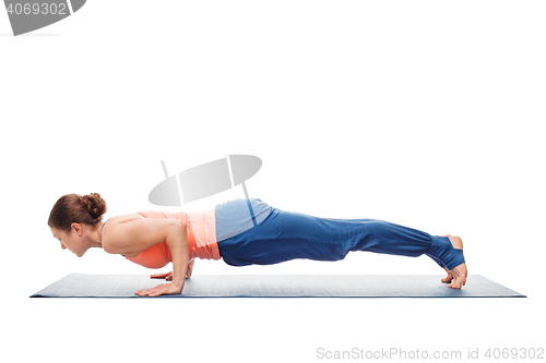 Image of Woman doing Ashtanga Vinyasa Yoga asana Chaturanga Dandasana