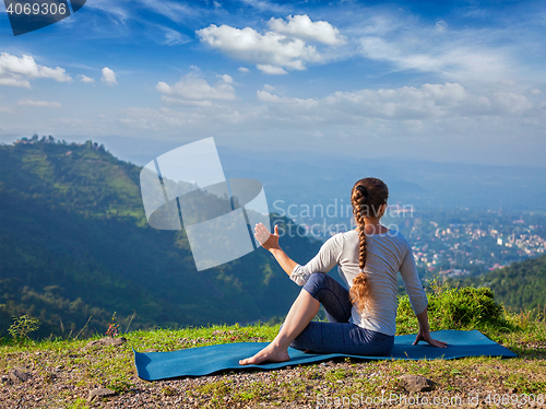 Image of Woman doing Hatha yoga asana outdoors