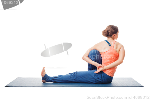 Image of Woman doing Ashtanga Vinyasa Yoga asana Marichyasana C