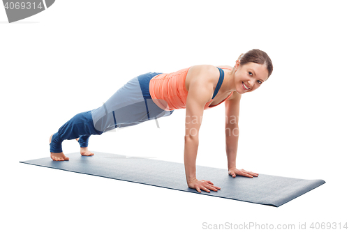 Image of Woman doing yoga asana Utthita chaturanga dandasana (or phalakasana)