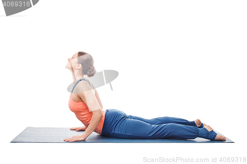 Image of Sporty fit yogini woman practices yoga asana bhujangasana