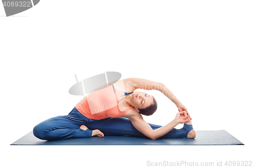 Image of Sporty fit yogini woman practices yoga asana parivrtta janu sirs