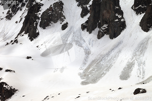 Image of Snow mountain with traces from avalanche in spring day