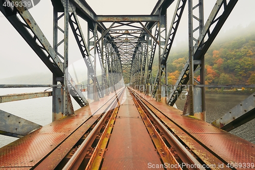 Image of Old railway bridge in foggy morning