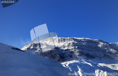 Image of Snow winter mountains at sun windy morning