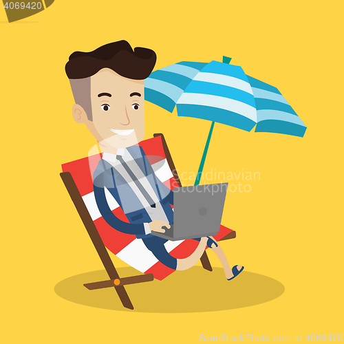 Image of Businessman working with laptop on the beach.