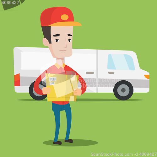 Image of Delivery man carrying cardboard boxes.