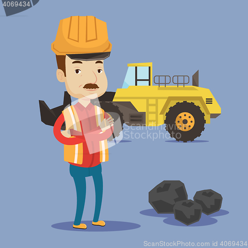 Image of Miner with a big excavator on background.