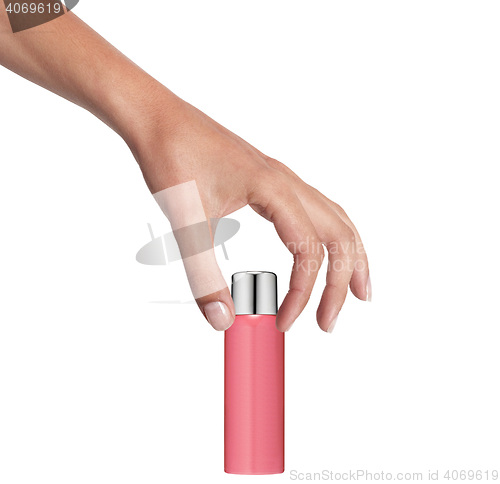 Image of Female hand with a cosmetics bottle