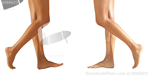 Image of Two pairs female legs on a floor