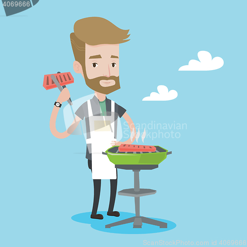 Image of Man cooking meat on barbecue grill.