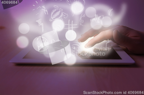 Image of The tablet with the hand on table