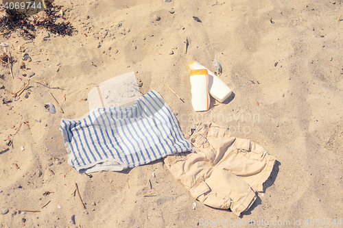 Image of Kids clothes on a sandy beach