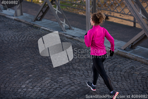 Image of sporty woman jogging on morning