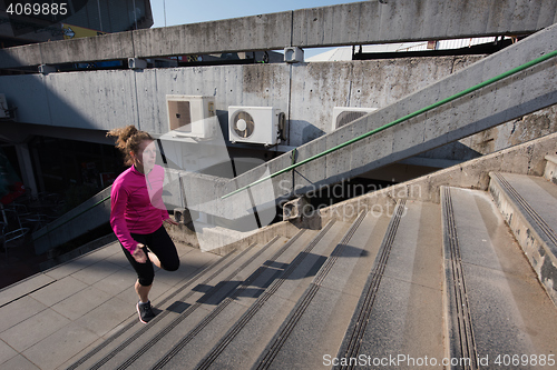 Image of woman jogging on  steps